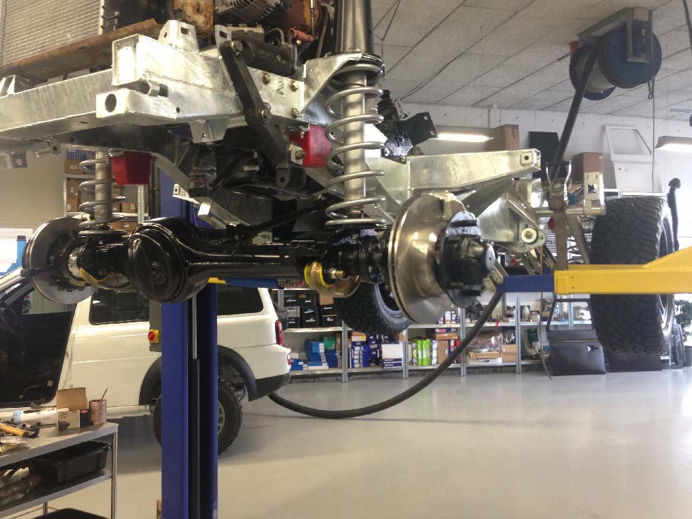 Defender med ny ramme og aksler på liften hos LR Parts